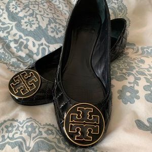 Quilted  black patent leather flats.